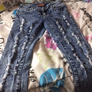 all ripped dark blue jeans